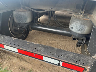 Trailer undercarriage showing dual air springs and reinforcement beam in a Utility 4000 AE flatbed trailer.