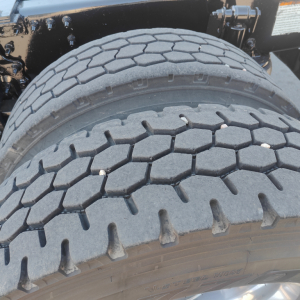 Truck rear dual tires showing tread pattern and sidewall details.