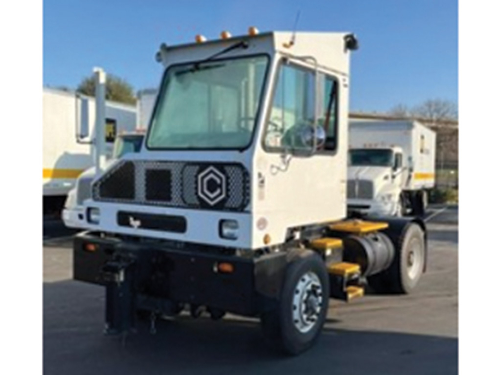 Truck cab front view with Renault logo, TJ9000 capacity label not visible, white cab, black chassis, no trailer.