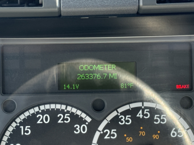 Odometer reading 263,376.7 miles on a Freightliner CA11364DC dashboard. Digital display shows 14.1V and 81°F; brake light illuminated.