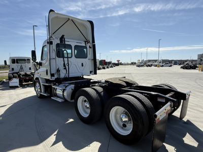 Freightliner CA11364DC truck tractor rear view showing wheels and fifth wheel, cab with raised sleeper, white exterior, GVW/axle area not legible.