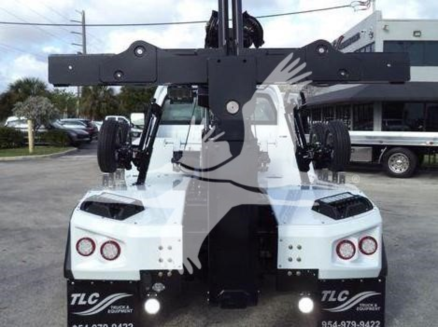 Front view of a 2023 Chevrolet Silverado 6500HD with a large winch/boom lifting apparatus mounted above the cab.