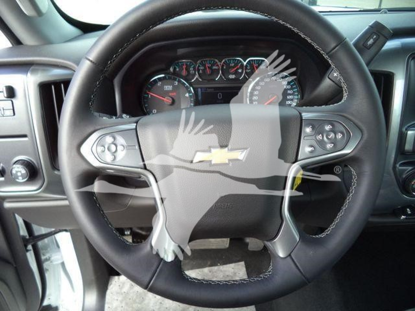 Steering wheel and dashboard of a 2023 Chevrolet Silverado 6500HD interior showing gauges and steering controls.