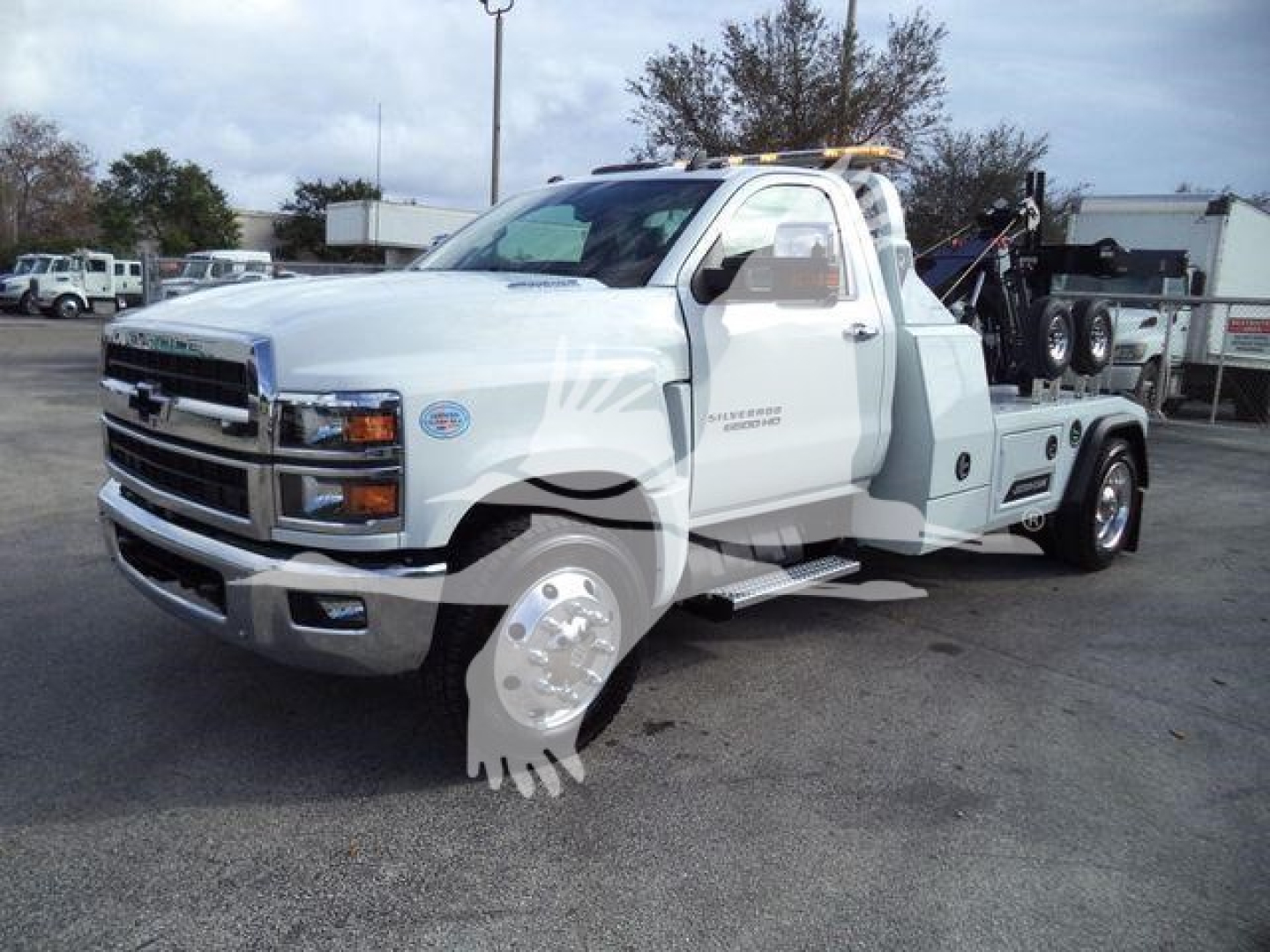 Chevrolet Silverado 6500HD tow truck in white with off-road style graphic on door and tow equipment on bed, stock number CHV6500MPL40 visible.