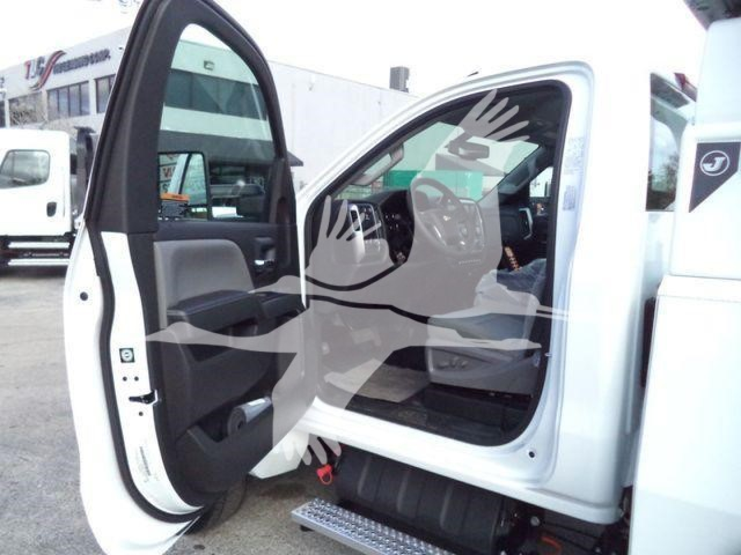 Truck cab interior of a white Chevrolet Silverado 6500HD with front doors open, showing dashboard and seating, stock image watermark overlaid.