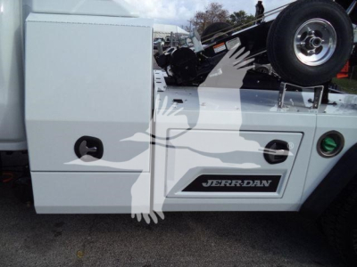 Truck side showing white storage compartment, wheel, and Jerr-Dan logo on door. Visible text includes JERR-DAN on the side panel.