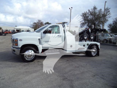 Chevrolet Silverado 6500HD tow truck side view showing winch equipment and front cab
