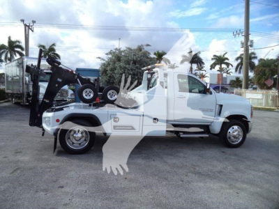 Chevrolet Silverado 6500HD tow truck side view with winch under hood text visible.