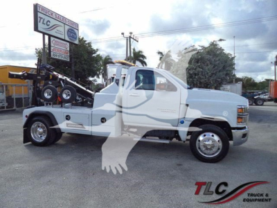Chevrolet Silverado 6500HD tow truck side view showing winch equipment and service body with TLC logo watermark.