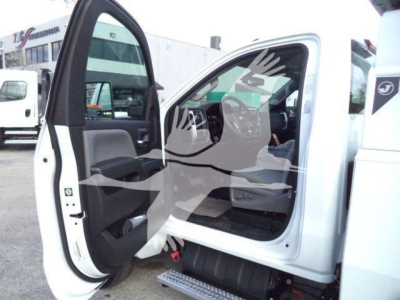 Truck cab interior of a white Chevrolet Silverado 6500HD with front doors open, showing dashboard and seating, stock image watermark overlaid.