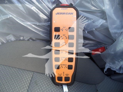 Winch controller labeled Jerr-Dan with multiple buttons and indicators in orange housing.