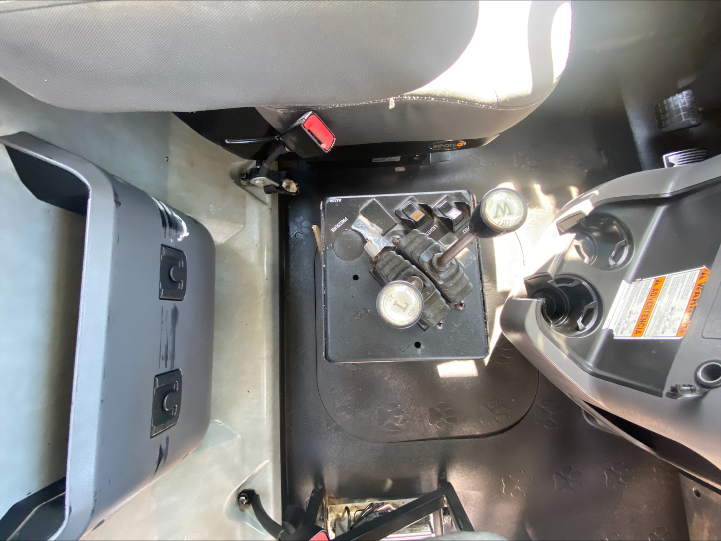 Cab interior of 2018 Mack GU533 showing gear shift lever, pedal area, and center console with gear selector and control panel.