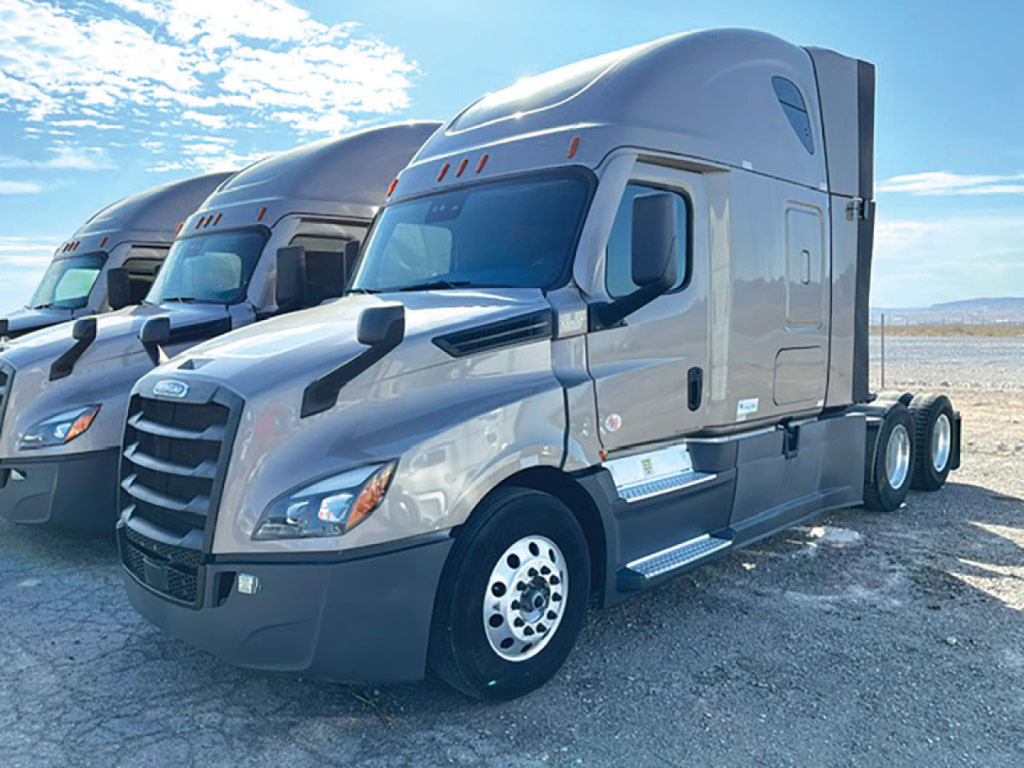 Freightliner Cascadia126 sleeper cab tractor from front-left angle showing chrome grille, aerodynamic mirrors, and dual rear axles.