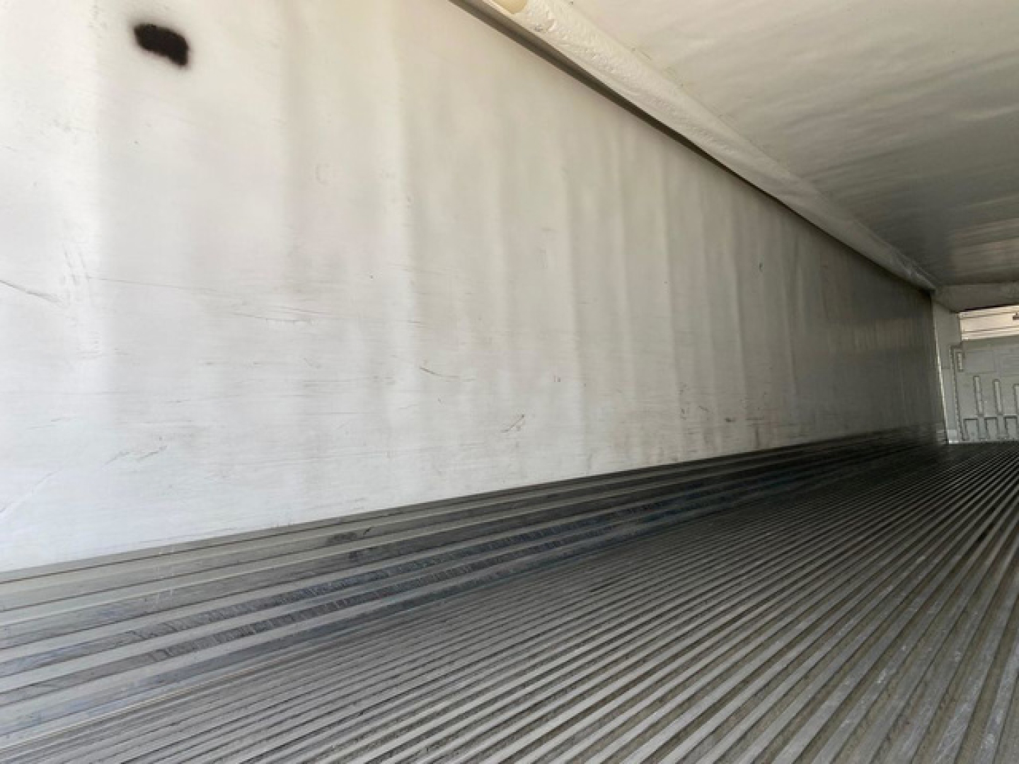 Trailer interior with ribbed floor and white walls showing cargo area in a 2018 Utility Reefer trailer.