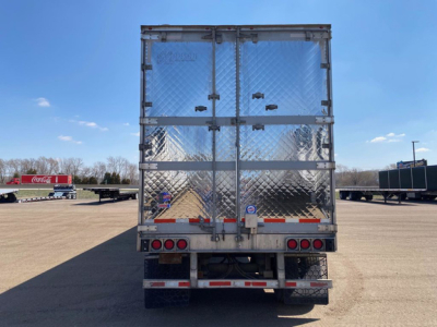 Trailer rear view of a 2018 Utility Reefer with diamond plate aluminum doors, dual rear doors, taillights, and reflective tape. VIN 1UYVS253XJ2007317 visible in listing.