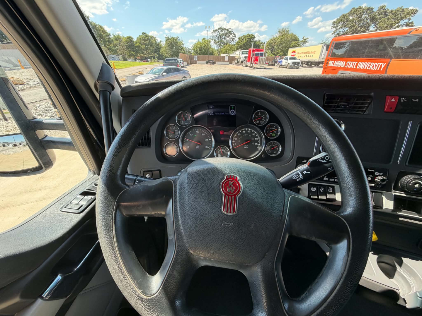 Kenworth T680 interior view from driver seat showing steering wheel and instrument cluster in a sleeper tractor.