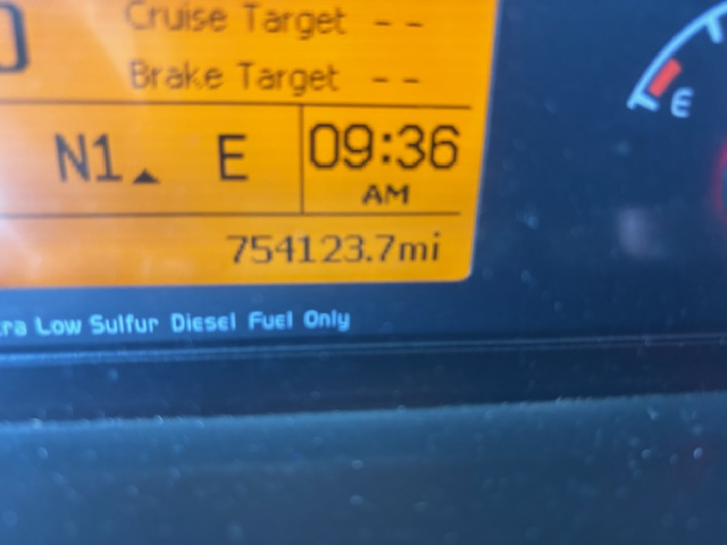 Volvo VNL780 dashboard display showing 09:36 AM, N1 E, and 75,412.3 miles with Blue gauge and orange warning area.