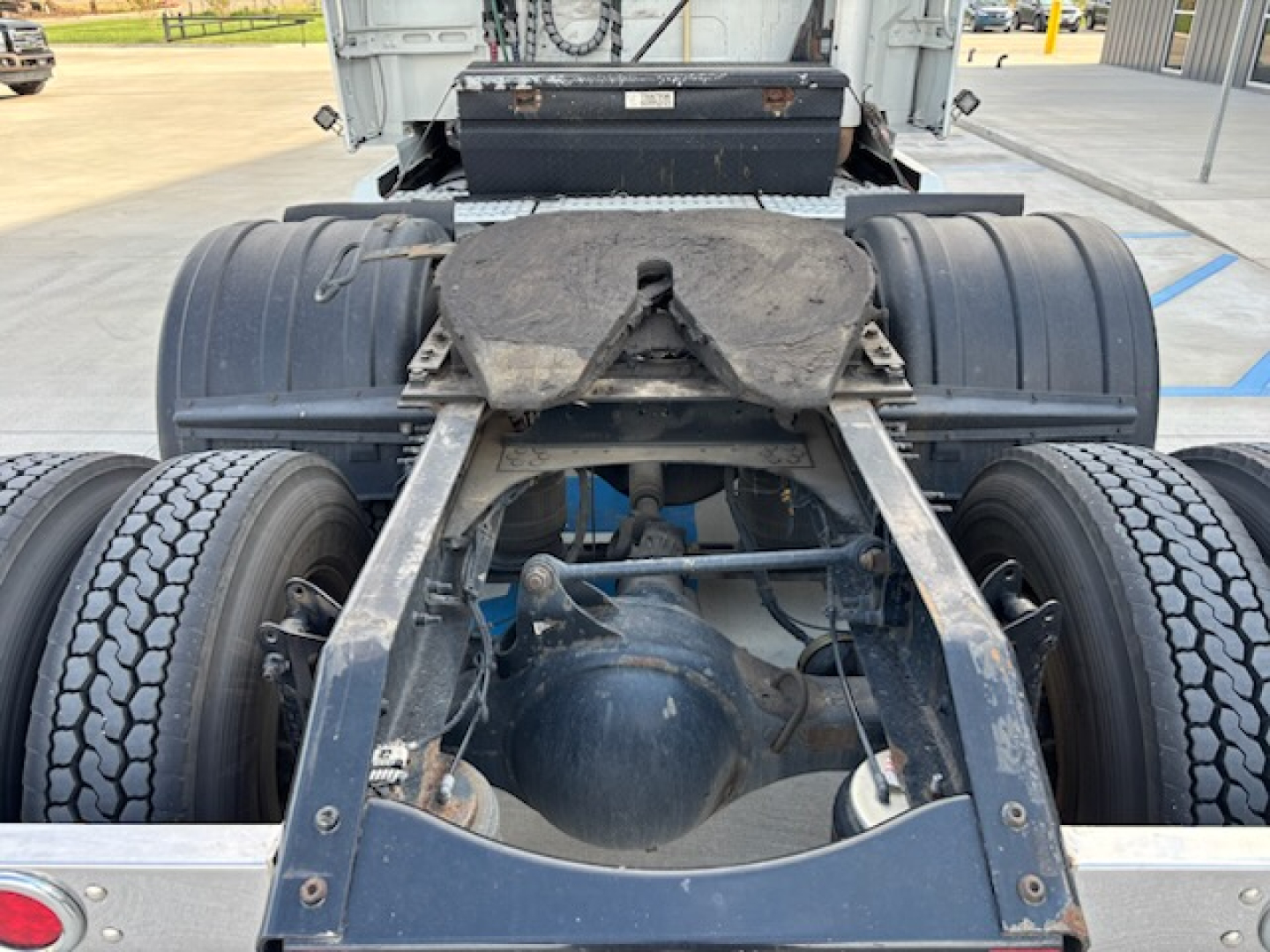 Truck rear chassis and fifth wheel of a Volvo VNL780 tractor showing dual rear axles and fifth wheel plate.