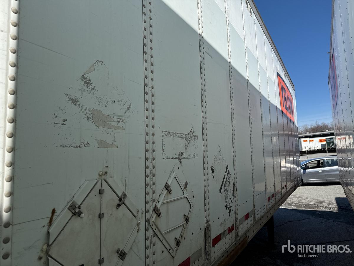 Trailer side of a 2004 Wabash DVDBHPC trailer showing riveted aluminum panels and rear door hardware.