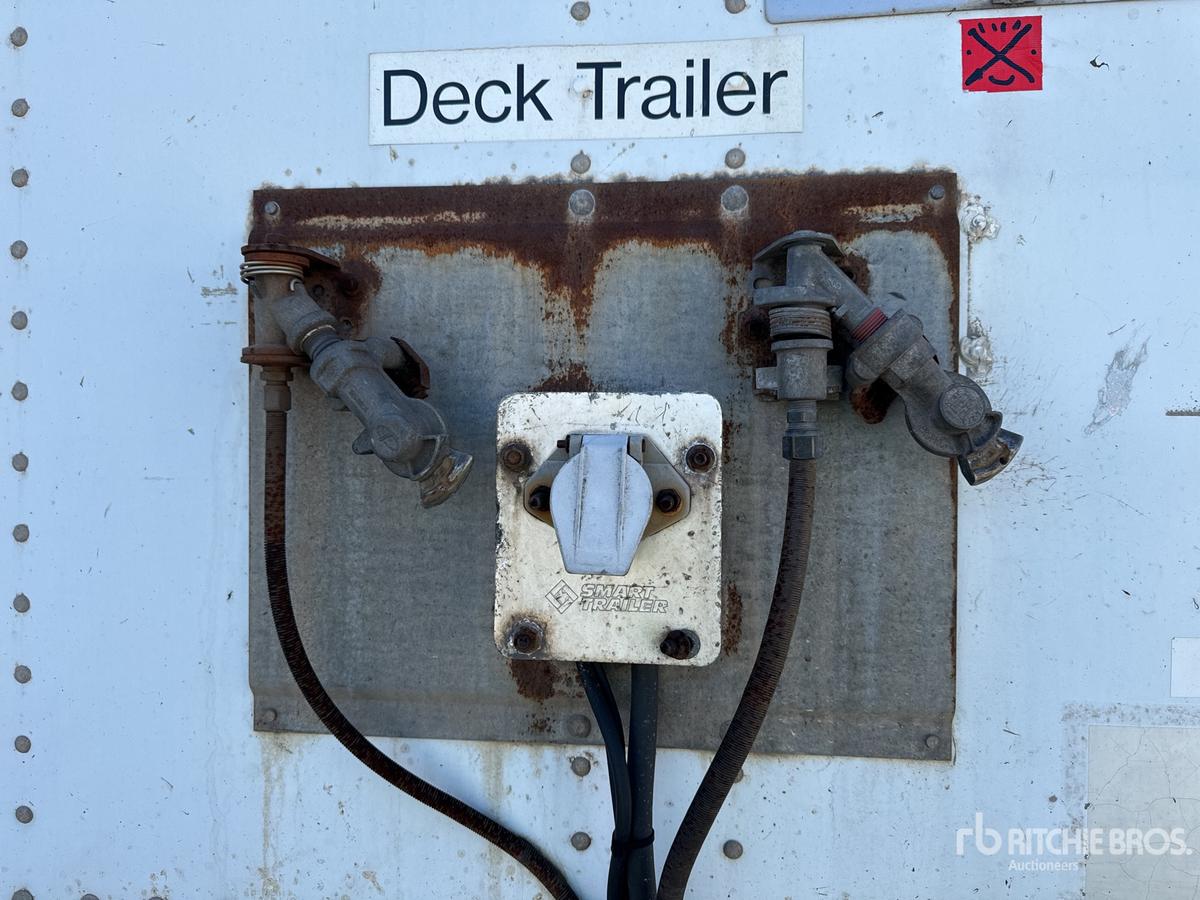 Deck trailer back showing electrical control box and hoses, with rusted metal plate, labeled Deck Trailer, and two hitch connections.