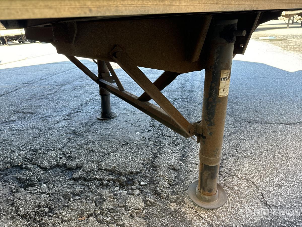 Trailer landing gear and support leg of a used 2004 Wabash DVDBHPC trailer showing the undercarriage and support jack.