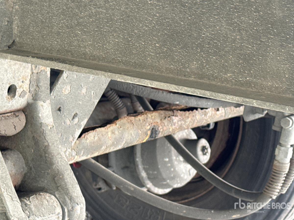 Trailer wheel area showing a portion of the drum and suspension with rusted components on a Wabash trailer.
