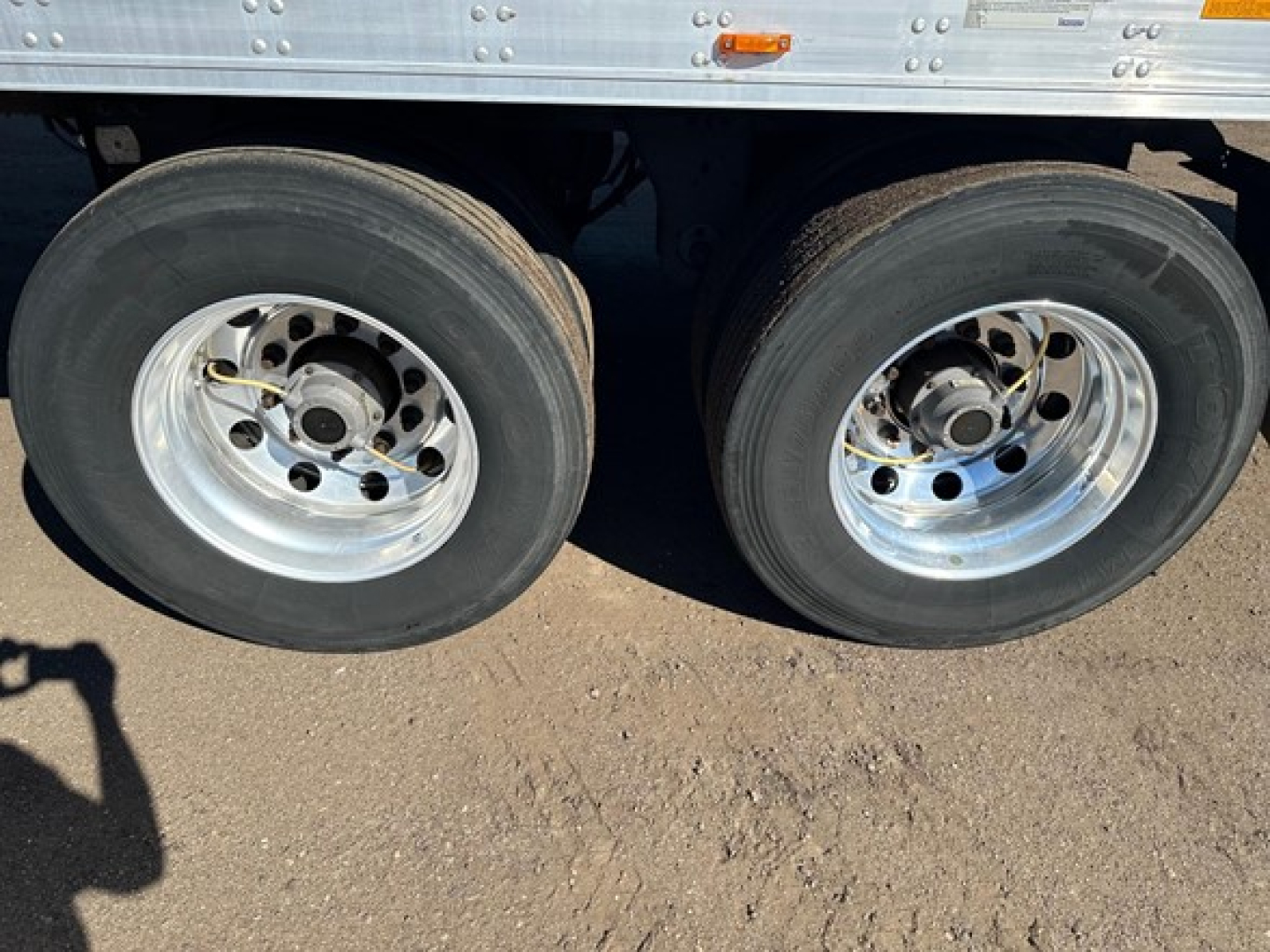 Trailer wheel pair for a 2019 Utility 3000R reefer trailer showing dual rear axles with polished aluminum rims and black tires.