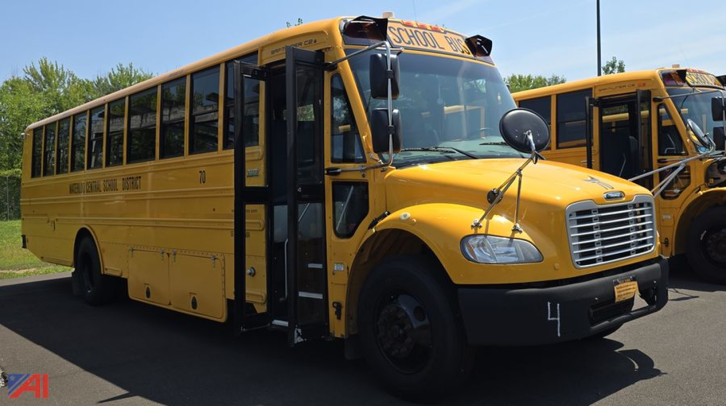School bus front-left view showing yellow Freightliner Thomas B2 C2 with open door.