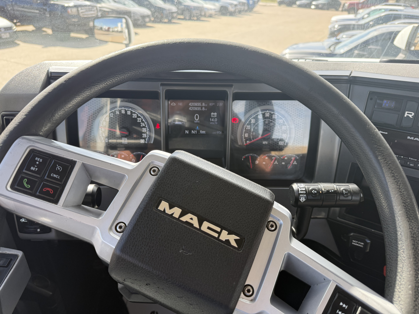 Mack AN42T truck interior steering wheel with Mack emblem and instrument cluster visible.