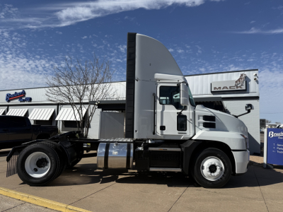 Truck side view of a 2022 Mack AN42T daycab showing cab and chassis with fuel tank and wheels.