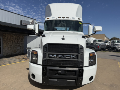 Mack AN42T conventional daycab truck front view with large black grille and white cab.