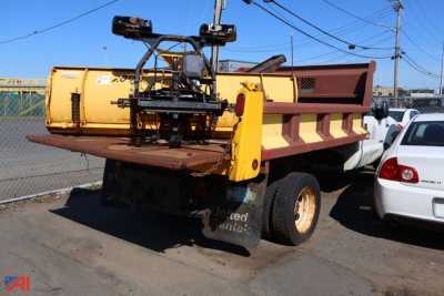 Dump bed of a Ford F-550 Super Duty dump truck showing yellow equipment and rear view with tailgate.