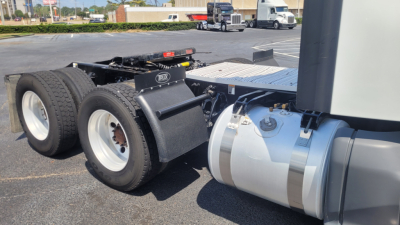 Peterbilt 579 tractor chassis showing rear dual axle wheels and fuel tank with connected cab; side view reveals standard fifth wheel area and chassis components.