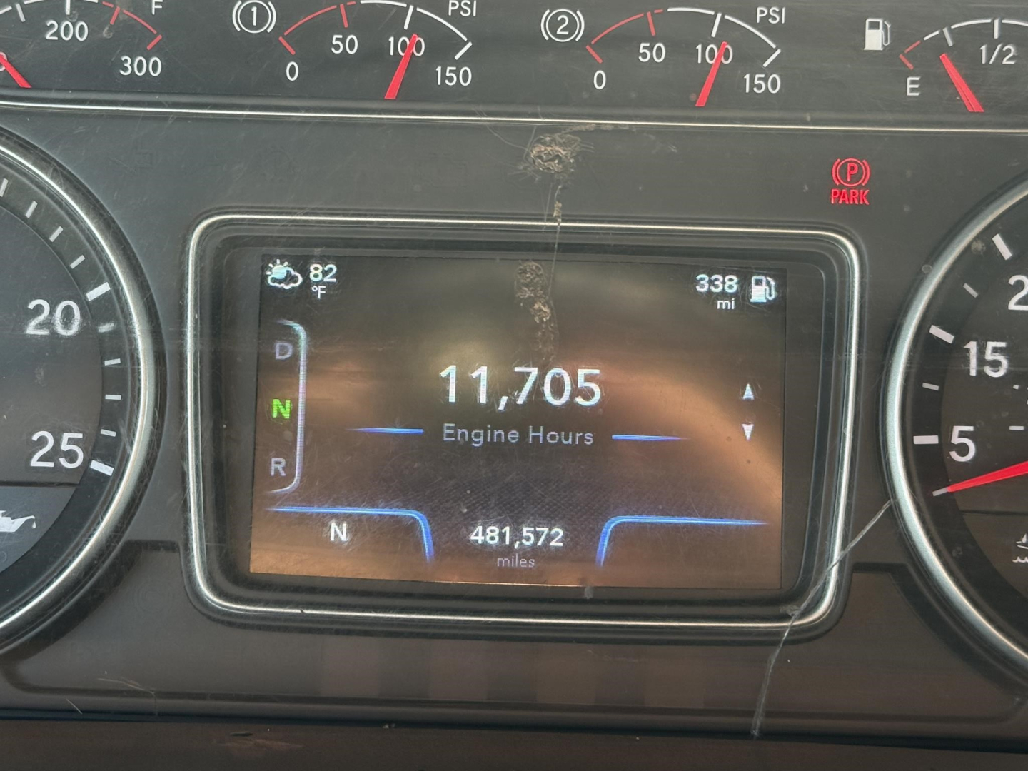 Dashboard LCD showing engine hours 11,705 and 481,572 miles with gear indicator and 82% fuel? on International LT truck.