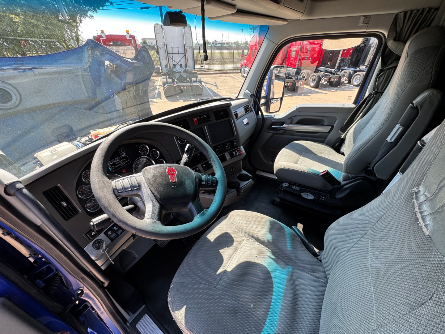 Image of the Kenworth T680 truck interior showing steering wheel, driver's seat, and dashboard with visible gauges and controls.