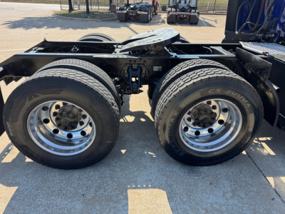 Kenworth T680 trailer-axle area showing dual rear wheels and chassis frame with fifth wheel plate.