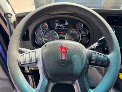 Kenworth T680 steering wheel and dashboard view showing gauges and controls.