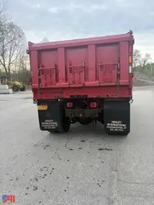 Dump truck rear showing plow wing and sander equipment on a red 2007 International WorkStar 7500 with Heilay branding on mud flaps.