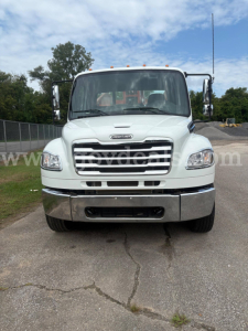 Freightliner M2 106 front view showing grille, headlights, and chrome bumper