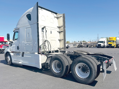 Freightliner Cascadia 126 tractor in side view showing sleeper cab and rear chassis with dual rear axles and trailer hitch area.