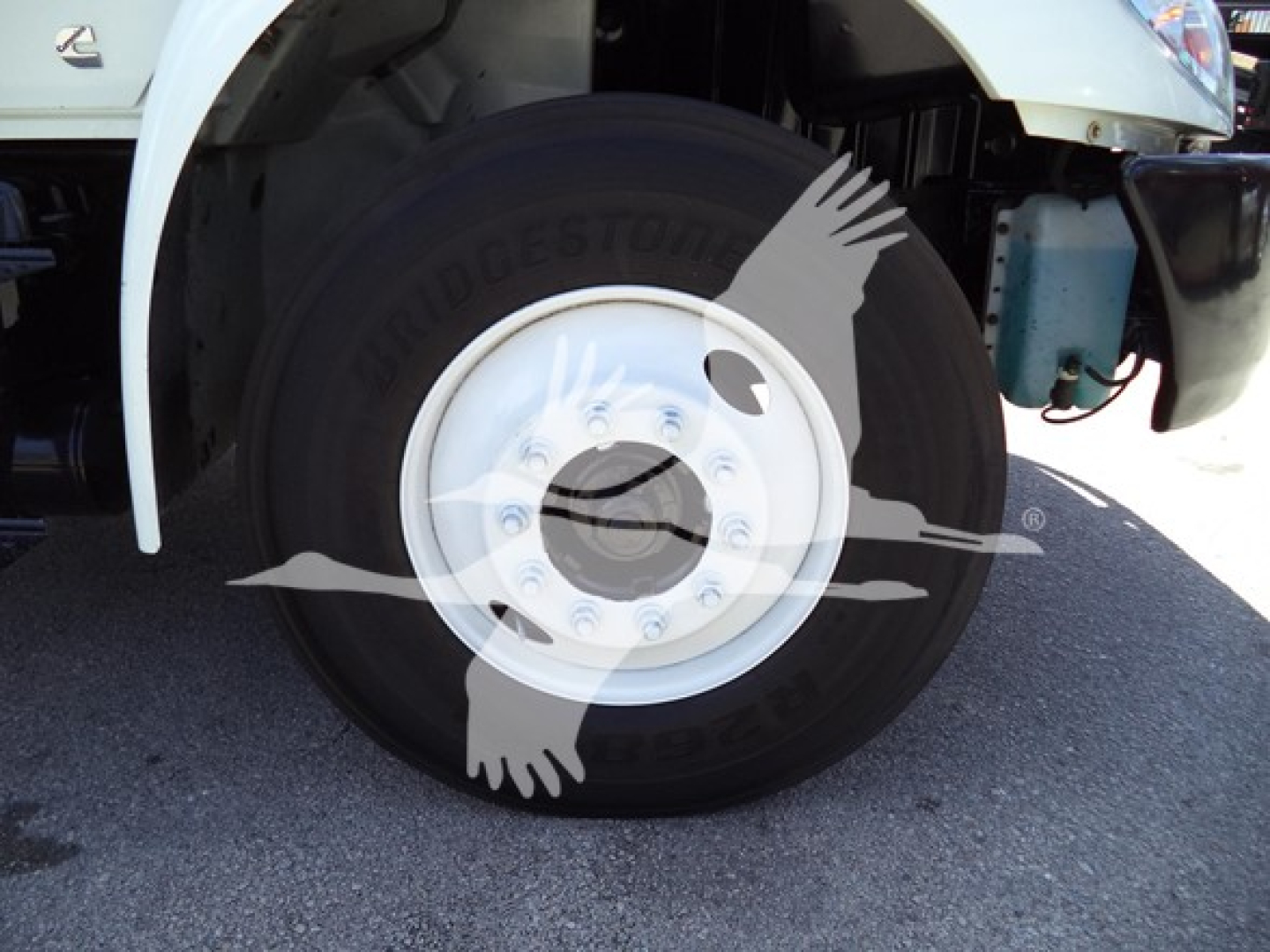Wheel and tire close-up on front right of a 2021 International MV truck showing Bridgestone tire and wheel hub.