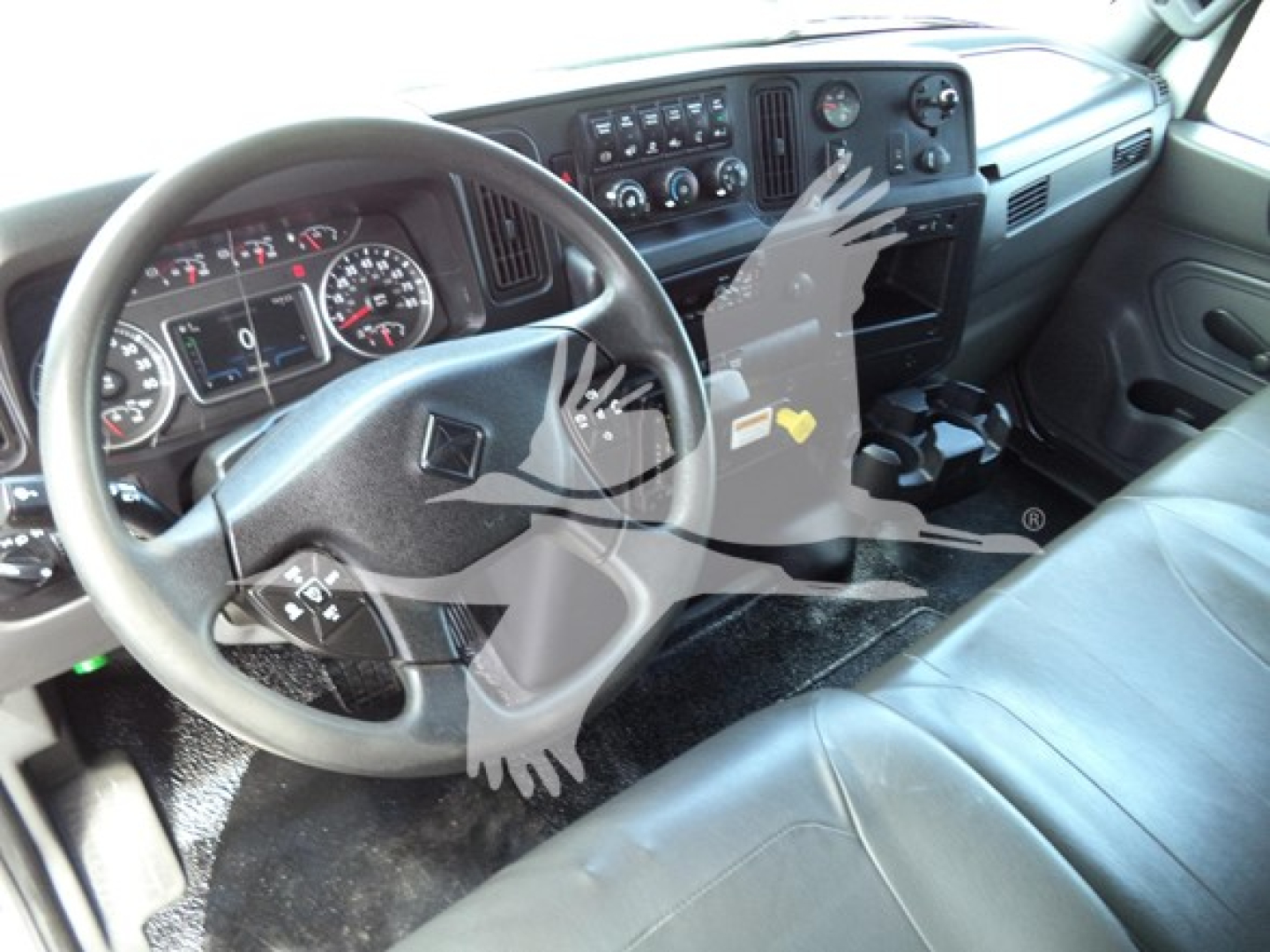 Interior of 2021 International MV truck cab showing steering wheel, dashboard, and center console.