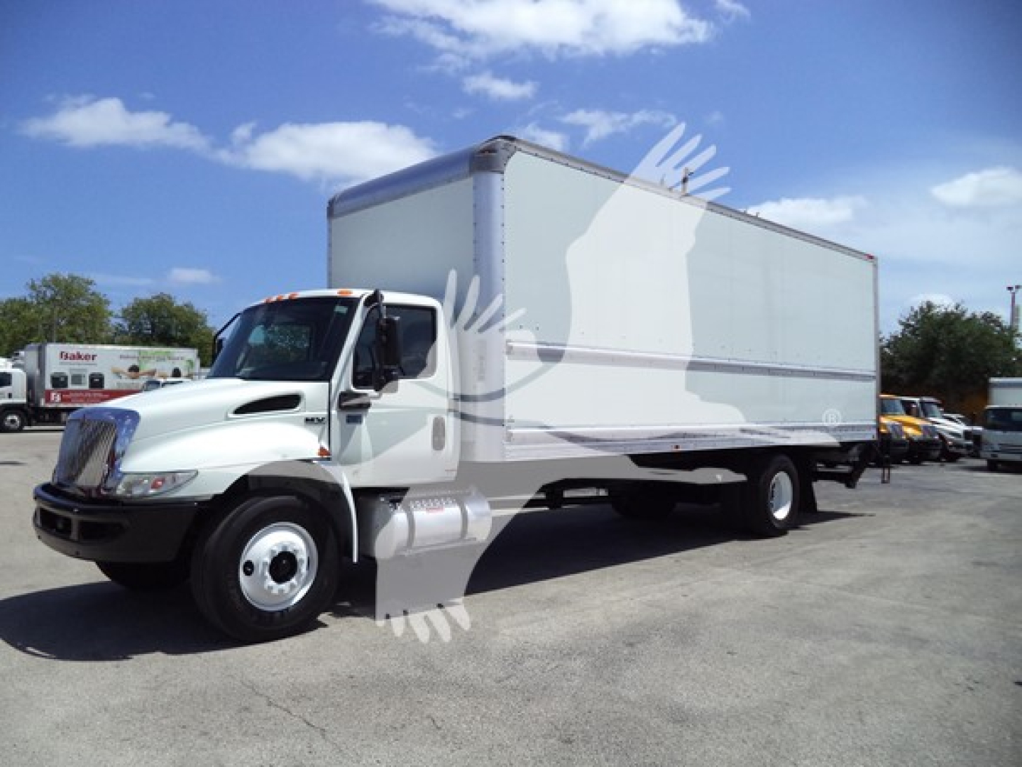 Box truck showing International MV with long white box body and front cab, side view
