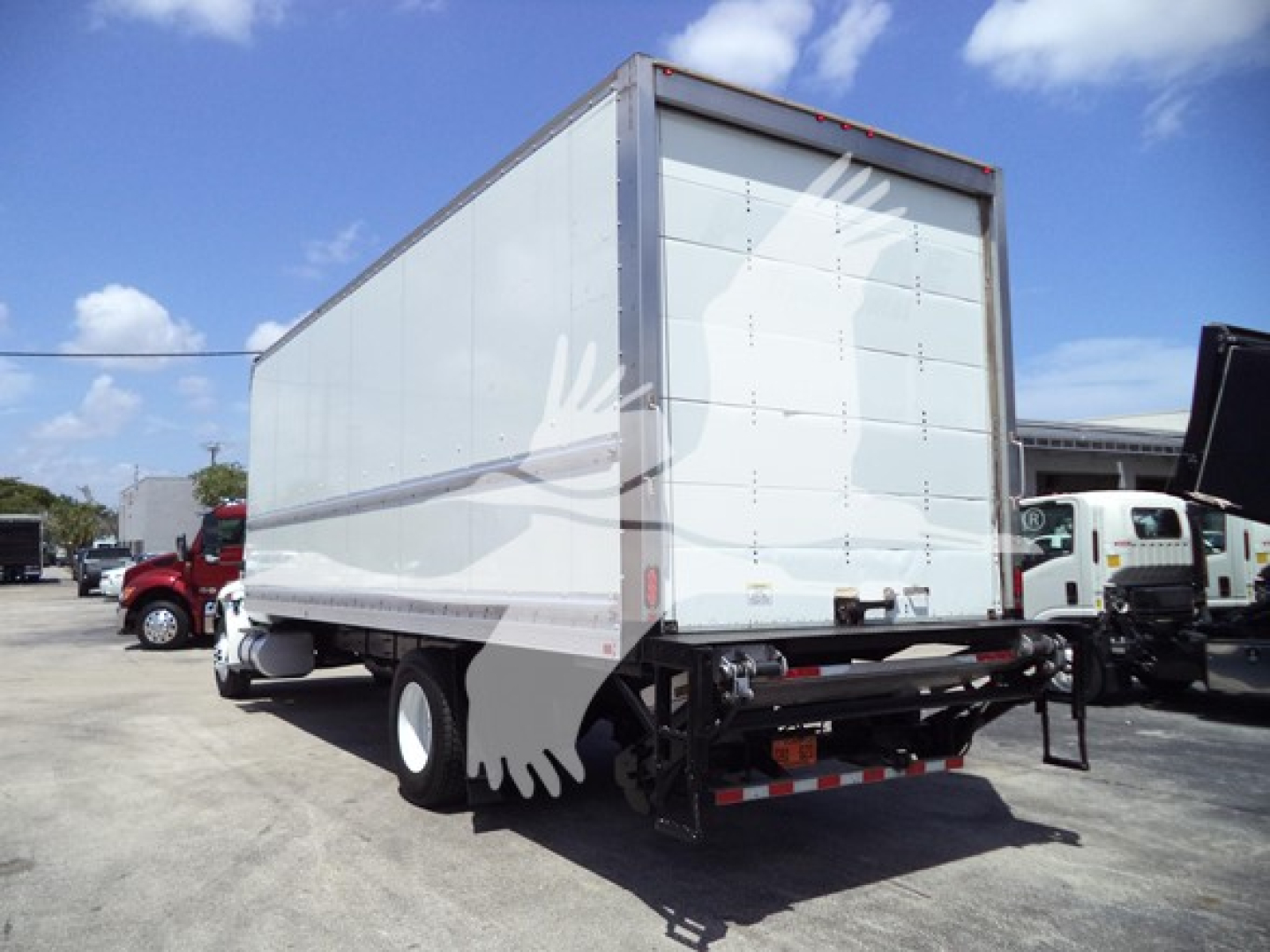 Box truck rear and side view showing cargo box and chassis with dual rear wheels, blank white panels on box, and reflective bumper markings.