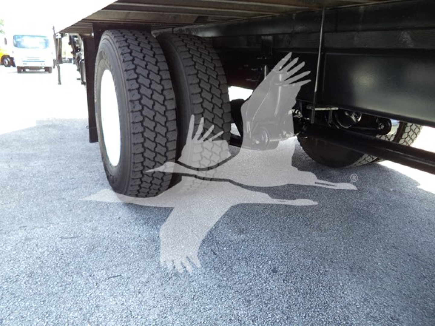 Truck undercarriage showing dual rear tires and underbody components on a 2021 International MV box truck