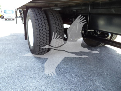 Truck undercarriage showing dual rear tires and underbody components on a 2021 International MV box truck