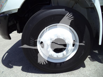 International MV truck wheel showing steel white rim and tire with lug nuts and hub cap.