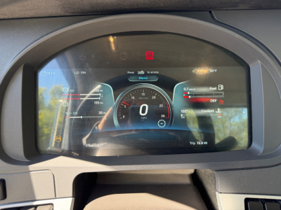 Kenworth T880 dashboard digital instrument cluster showing speed 0 mph, warning icons, and fuel/coolant gauges.
