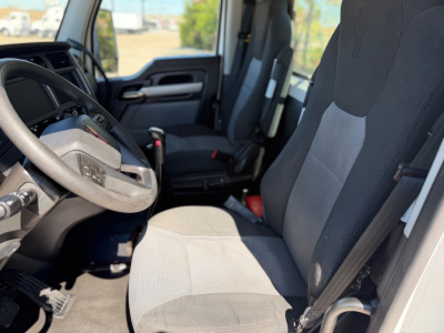 Kenworth T880 interior with steering wheel and dual front seats, gray fabric upholstery visible.