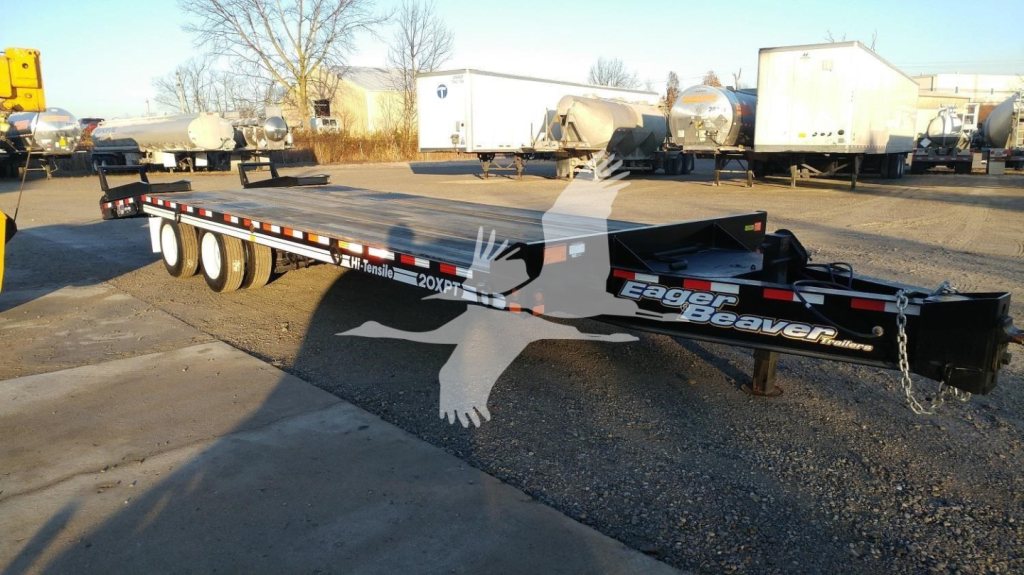 Eager Beaver 20XPT trailer showing logo and model on black flatbed with white lettering and chain hitch.
